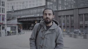 Tareq Alaows steht vor dem Bahnhof Friedrichstraße in Berlin