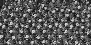 Schwarz-weiß Foto von Dutzenden aufgereihten Soldaten