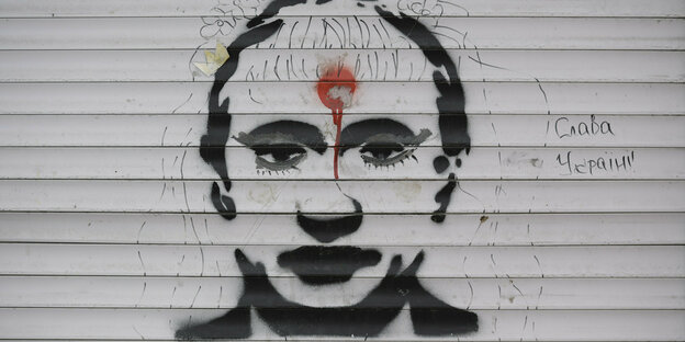 Graffiti mit dem Kopf Putins und einem roten Punkt in der Stirn, daneben steht "Sieg der Ukraine"