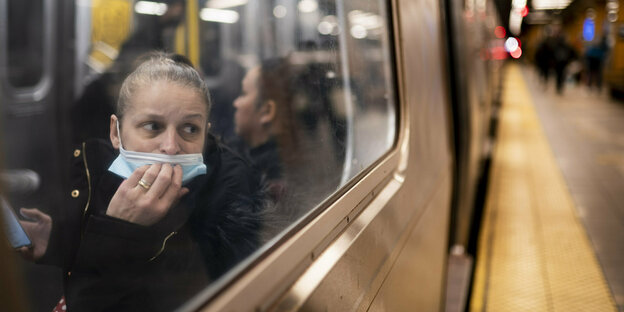 Eine Frau blickt auf den Bahnsteig in der U-Bahn-Station