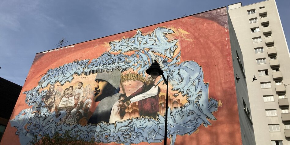 Graffitti für die Einwanderung an einer Hochhauswand