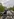 Blick von oben auf den Demonstrationszug. Vorne, links und rechts sind Polizeiketten