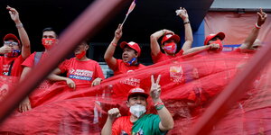 Begeisterte Anhänger von Bongbong feiern mit Partei- T-Shirts, Mützen und Flaggen