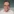 Portraitfoto von Helmut Schulzeck; er trägt ein gestreiftes Hemd und eine eckige Brille und lächelt