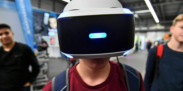 Ein Junge trägt eine weiße VR-Brille auf einer Berufsorentierungsmesse