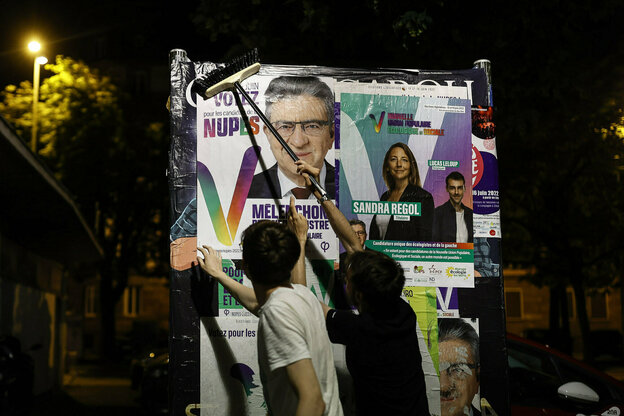 Plakatierer für Jean-Luc Mélenchons Partei "Nupes" in der Dunkelheit.
