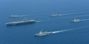 Militärschiffe fahren durch ein blaues Meer