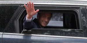 Frankreichs Präsident Macron winkt aus dem Auto
