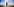 Sebastian Studnitsky steht mit verschränkten Armen auf einer Wiese vor einem Leuchtturm, der blaue Himmel im Hintergrund ist klar