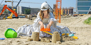 Eine Frau sitzt im Sand