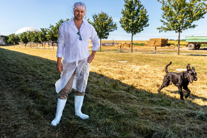 Benjamin Meise mit einem Schutzanzug auf dem Feld