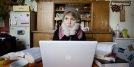 Studentin in Winterkleidung vor ihrem Laptop