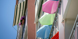 Viele bunte Sonnenschirme auf Balkonen