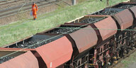 Ein offener Güterzug mit Kohle fährt auf einem Gleis