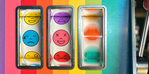 Die drei Spalten eines Spielautomats, in dem sich symbole drehen. Links ist ein trauriger Smilie in der Mitte ein lächelnder. Ganz rechts ist es verschwommen.