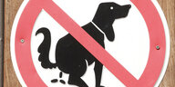 Ein Schild zeigt einen kotenden Hund, der durchgestrichen ist