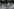 Christian Ströbele im gestreiften Hemd und mit Turnschuhen fährt auf seinem Fahrrad bei einer Fahrraddemo mit.