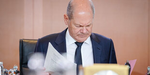 Olaf Scholz studiert am Kabinettstisch Akten