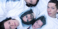 Die Mitglieder des Trios 13 Year Cicada liegen auf dem Boden übereinander, sie tragen weiße T-Shirts auf denen jeweils das Gesicht eines anderen Bandmitglieds abgebildet ist