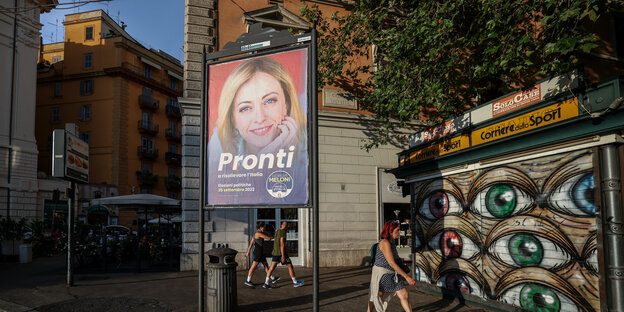 An election poster of right-wing politician Giorgia Meloni hangs on a street in a suburb of Rome