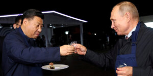 Chinas Präsident Xi Jinping und Wladimir Putin stoßen miteinander an - wahrscheinlich mit Wodka