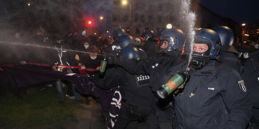 Polizisten sprühen mit Pfefferspray