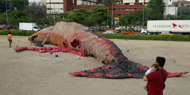 Das Bild zeigt eine Kunstinstallation: ein nachgebildeter toter Blauwal mit Plastik im Inneren.