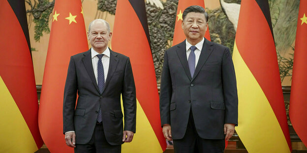 Olaf SCholz and Xi Jinping in front of German and Chinese flags