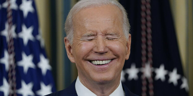 President Joe Biden smiles.