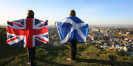 Zwei Personen mit einer britischen und einer Schottischen Flagge.
