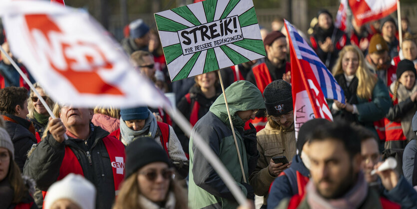 Menschen auf einer Demo tragen Plakate