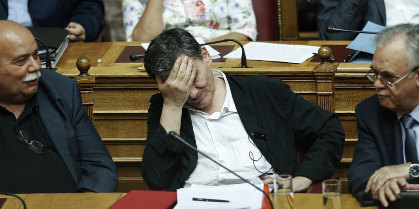 Finanzminister Euclid Tsakalotos hält sich die Hände vors Gesicht.