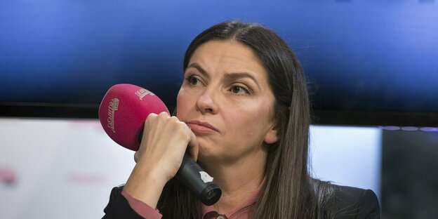 Journalist Natalya Sindeyeva with a microphone