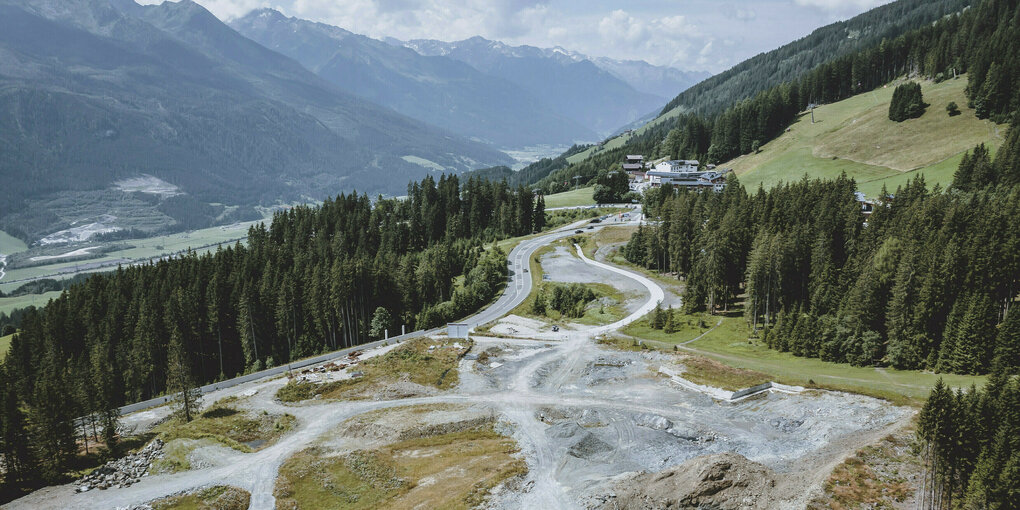 Großbaustelle vor einer Berglandschaft