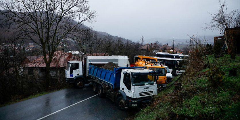 Lastkraftwagen stehen quer auf einer Fahrbahn