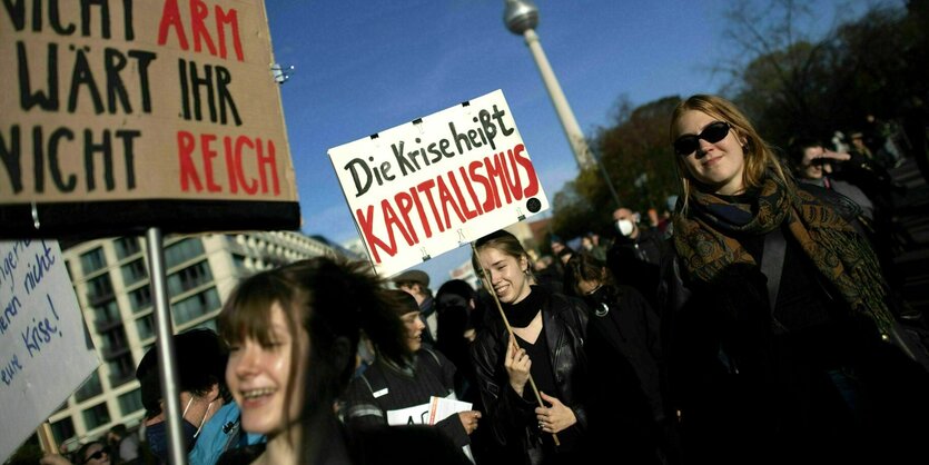 Demonstranten mit Schildern, Aaufschrift: Die Krise heißt Kapitalismus