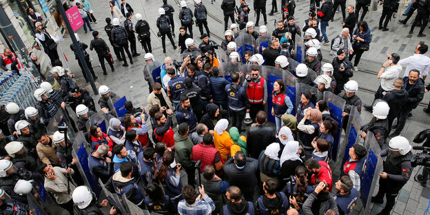 A group of people is surrounded by police officers