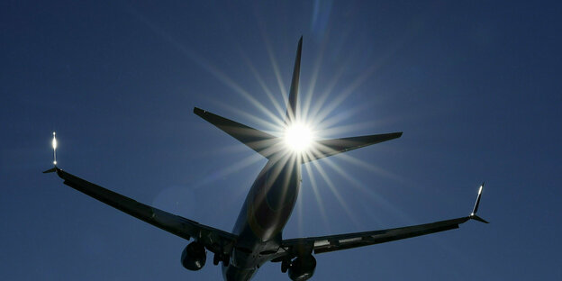 An airplane photographed against the sunlight