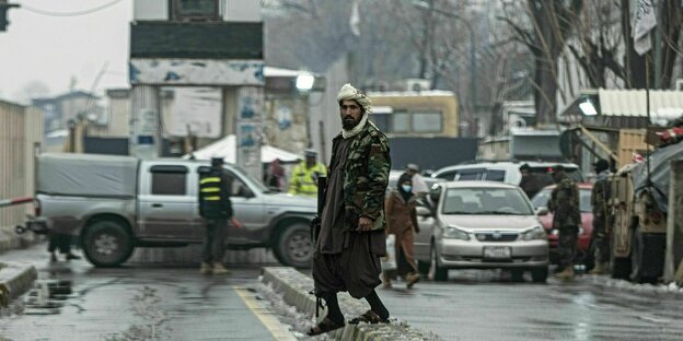 A Taliban guard with a gun on the street