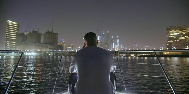 Bushido poses with his back to the camera in front of the Dubai skyline