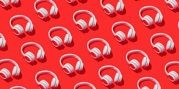 White headphones on a red background
