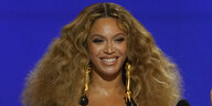 Portrait von Beyoncé mit offenen Haaren und großen Ohrringen