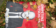 Ein Plakat zur Bundestagswahl 2021 von Olaf Scholz SPD liegt im Laub