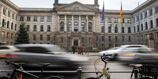 Autos fahren vor an einem historischen Gebäude vorbei