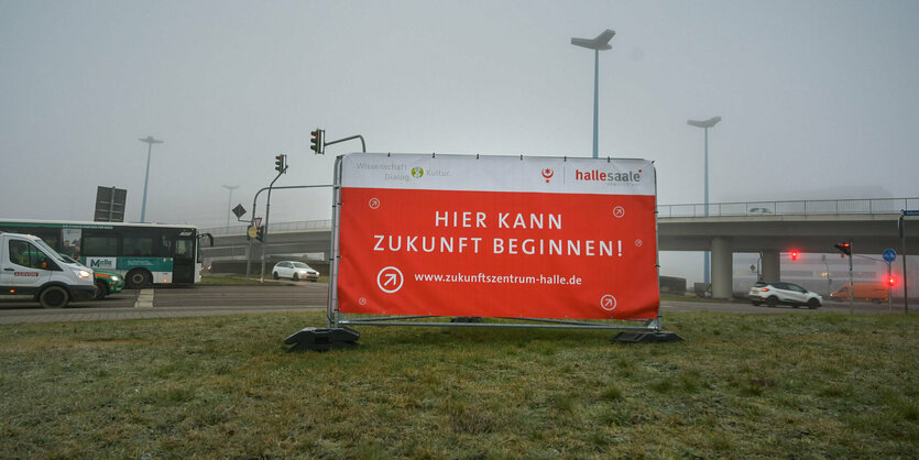 Auf einem Schild mit oranger Farbe steht "Hier kann Zukunft beginnen!"