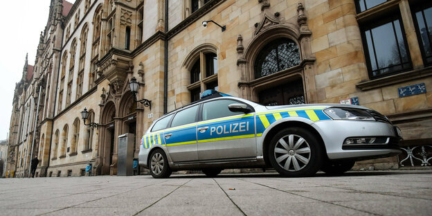 Police vehicle in front of old building