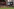 Fußballer gedeneken Chrsitian Atsu, hiter ihnen ein Bildschirm mit dem Foto des verstorbenen