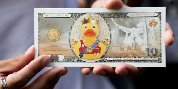 Badeente mit Krone auf einem Phantasiegeldschein bei einer Demo am 25. November 2020 in Bangkok.