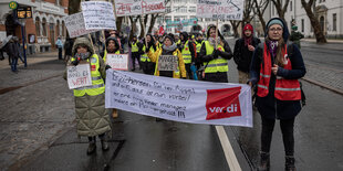 Eine Gruppe Demonstrierender mit Plakaten und Bannern