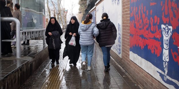 Street scene in Tehran, women with and without headscarves meet